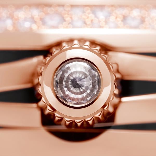 Close-up view of gold crown with inlaid diamond on Ladymatic ladies' watch